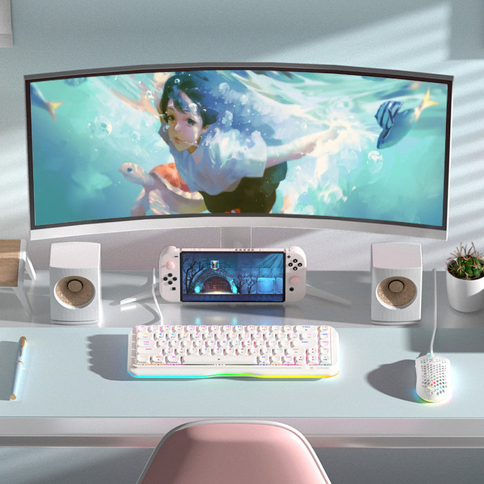 Gaming setup with a curved monitor, keyboard, mouse, and handheld gaming console on a desk.